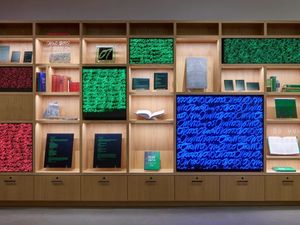 A curated grid of illuminated artwork panels and books from Google's art collection.