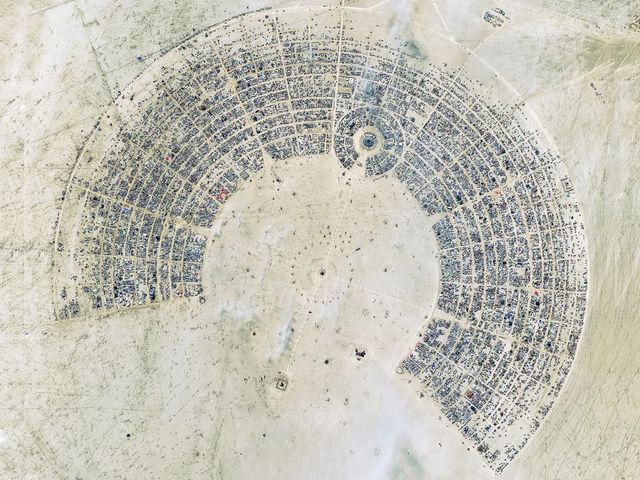Aerial view of Black Rock City — the circular street grid of Burning Man laid out on the desert playa.