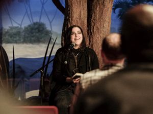 Josette Melchor telling a story on stage at the California Academy of Sciences during Noise Pop.