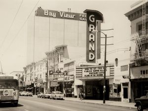 The historic Grand Theater marquee on Mission Street, San Francisco, in a vintage black-and-white photograph.