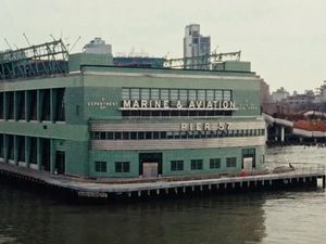 The historic green Marine & Aviation Pier 57 building on the Hudson River, New York.